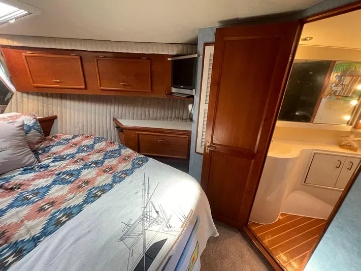 Occtane Yacht Photos Pics Cozy bedroom and bathroom in 1990 Ocean Yachts 44 Super Sport boat.