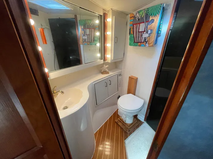 Occtane Yacht Photos Pics Bathroom interior of 1990 Ocean Yachts 44 Super Sport with mirror and wooden flooring.