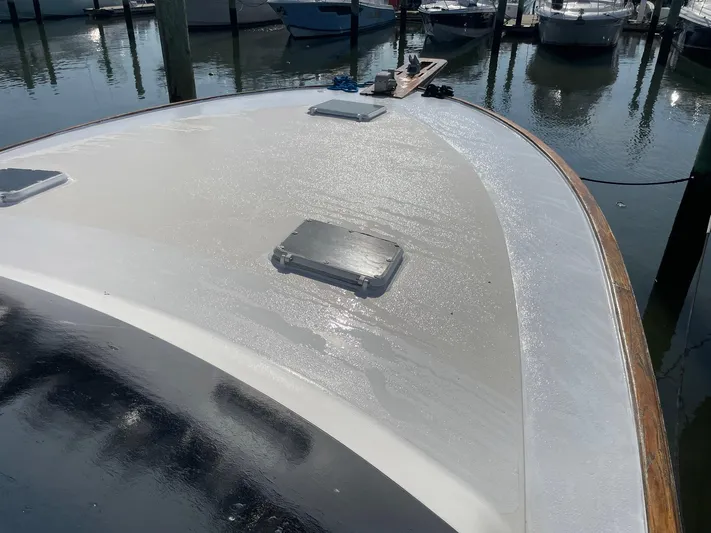 Occtane Yacht Photos Pics Bow of a 1990 Ocean Yachts 44 Super Sport, docked with a glistening deck.