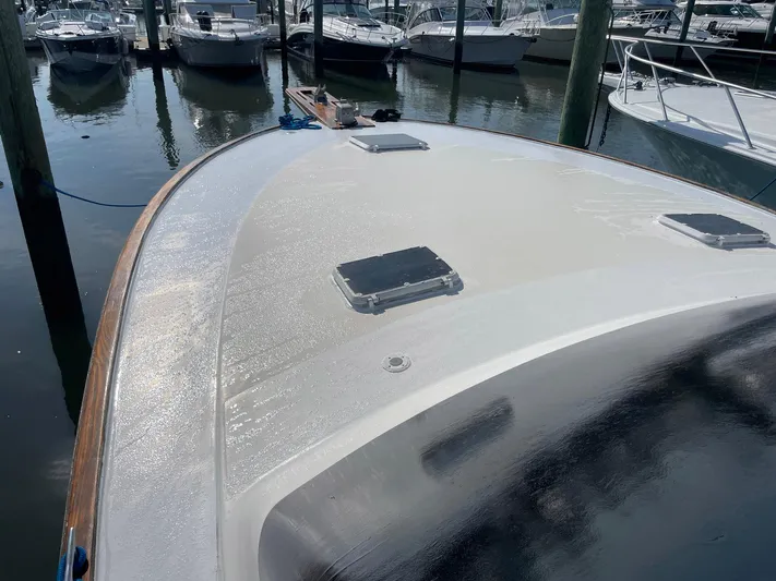 Occtane Yacht Photos Pics 1990 Ocean Yachts 44 Super Sport boat deck in marina, surrounded by other boats.