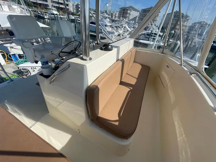 Occtane Yacht Photos Pics 1990 Ocean Yachts 44 Super Sport interior with helm, seating, and marina view.