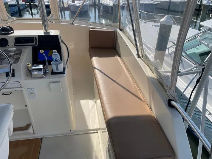 Occtane Yacht Photos Pics 1990 Ocean Yachts 44 Super Sport cockpit with helm, seating, and marina view.