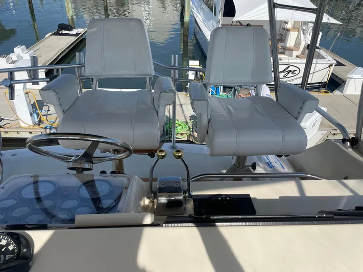 Occtane Yacht Photos Pics Helm of 1990 Ocean Yachts 44 Super Sport with dual captain chairs and steering wheel.