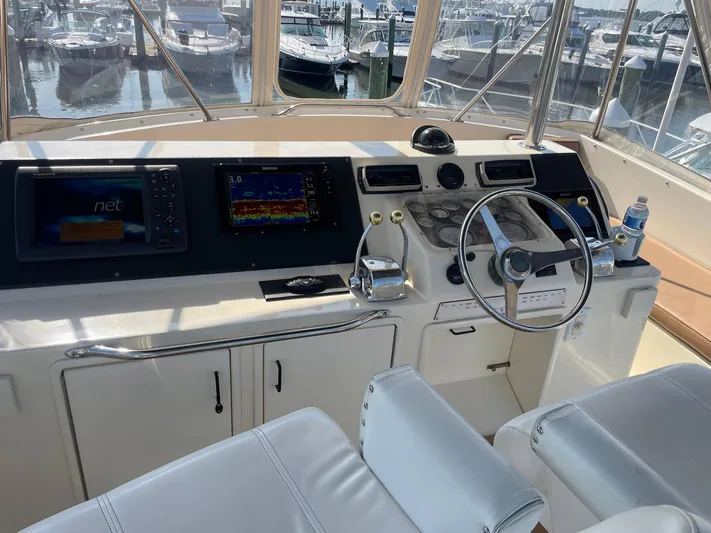 Occtane Yacht Photos Pics 1990 Ocean Yachts 44 Super Sport helm with navigation screens and controls in marina setting.