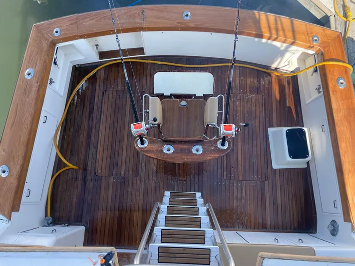 Occtane Yacht Photos Pics 1990 Ocean Yachts 44 Super Sport fishing deck with wooden flooring and fishing chairs.