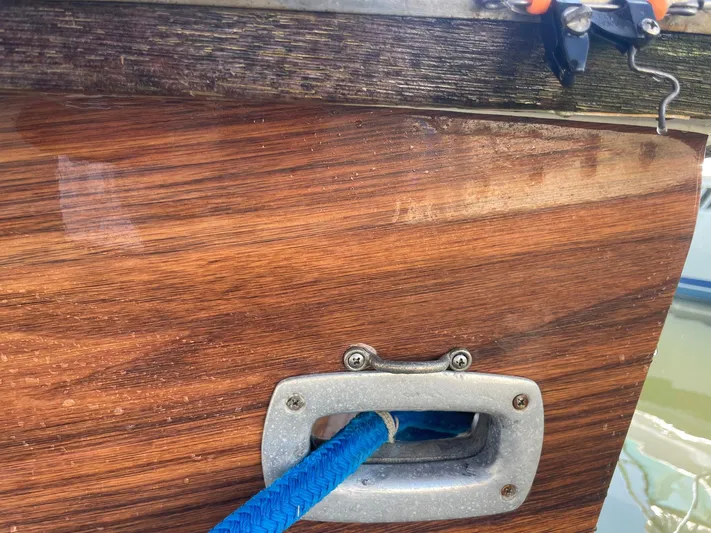 Occtane Yacht Photos Pics Close-up of Ocean Yachts 44 Super Sport 1990, featuring wood panel and blue rope detail.