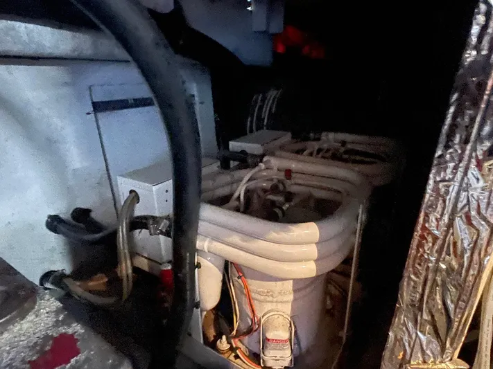 Occtane Yacht Photos Pics Engine room of 1990 Ocean Yachts 44 Super Sport with visible piping and machinery.