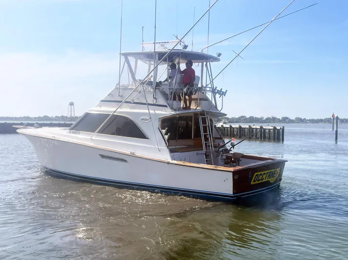 Occtane Yacht Photos Pics 1990 Ocean Yachts 44 Super Sport boat on water, clear sky, fishing rods visible.