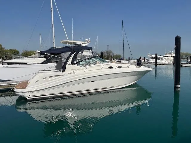  Yacht Photos Pics 2003 Sea Ray 340 Sundancer yacht docked in a marina on a sunny day.