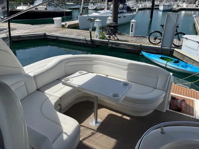  Yacht Photos Pics 2003 Sea Ray 340 Sundancer boat interior with white seating and table at marina.