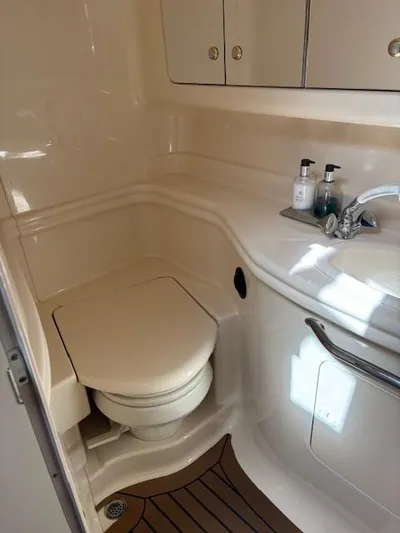  Yacht Photos Pics 2003 Sea Ray 340 Sundancer bathroom with toilet, sink, and storage cabinets.