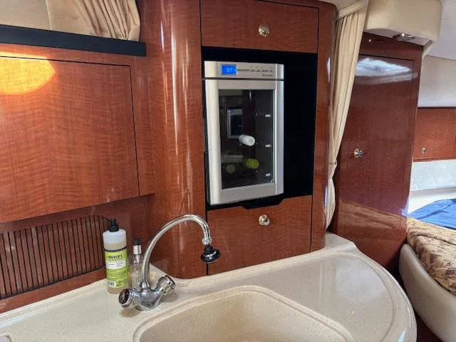  Yacht Photos Pics Luxurious 2003 Sea Ray 340 Sundancer yacht interior with kitchenette and mini fridge.