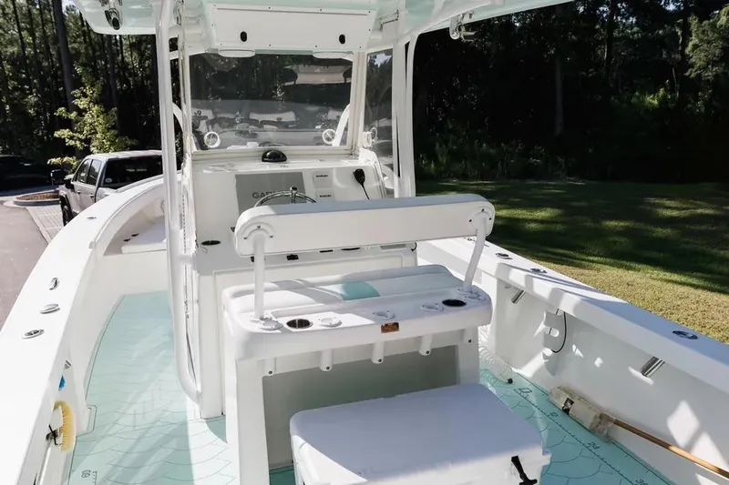  Yacht Photos Pics 2017 Albury Brothers center console boat with seating and steering wheel, parked outdoors.