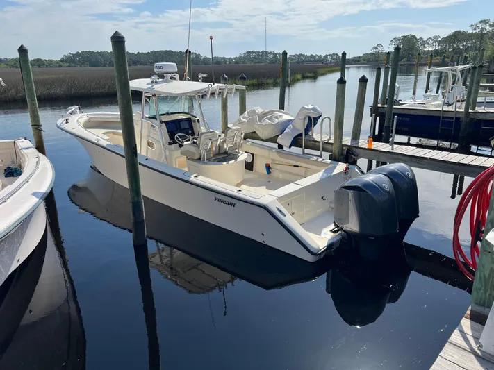  Yacht Photos Pics 2009 Pursuit 3400 Offshore boat docked with dual engines, calm water, and clear sky.