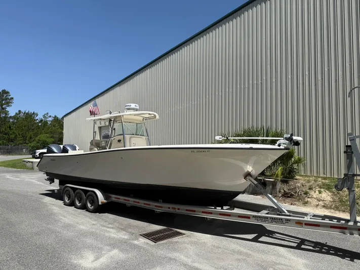  Yacht Photos Pics 2009 Pursuit 3400 Offshore boat on trailer, parked outdoors near a large building.
