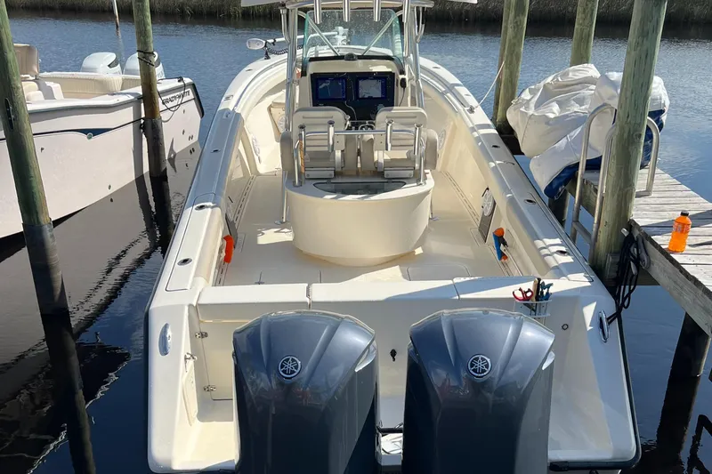  Yacht Photos Pics 2009 Pursuit 3400 Offshore boat docked, featuring dual Yamaha engines and a spacious deck.