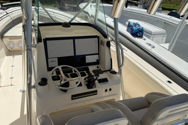  Yacht Photos Pics 2009 Pursuit 3400 Offshore boat cockpit with dual Simrad displays and steering wheel.