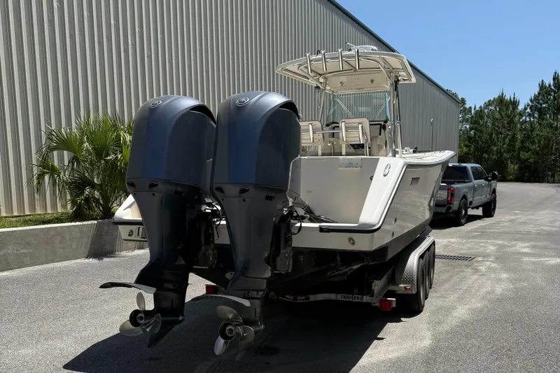  Yacht Photos Pics 2009 Pursuit 3400 Offshore boat with dual outboard motors on a trailer.