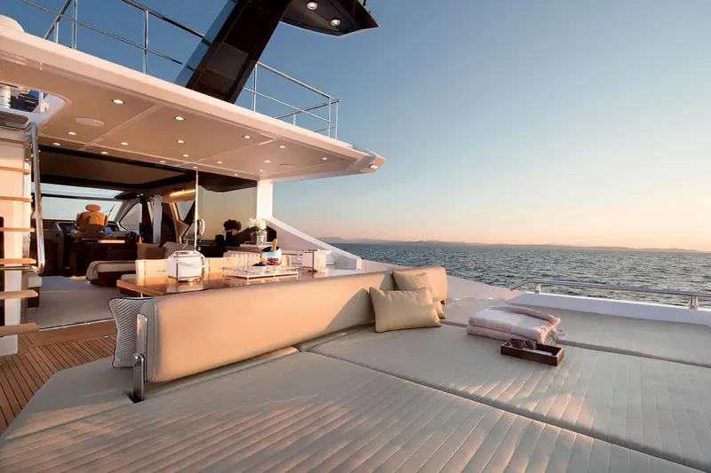  Yacht Photos Pics Luxurious 2015 Azimut 77S yacht deck with elegant seating and ocean view at sunset.
