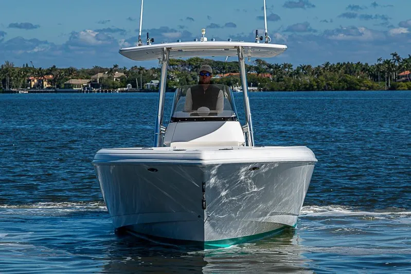  Yacht Photos Pics 2005 Intrepid 300 Center Console boat cruising on a sunny day.