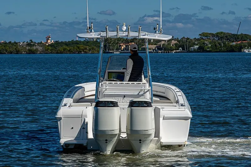  Yacht Photos Pics 2005 Intrepid 300 Center Console boat cruising on a calm lake.