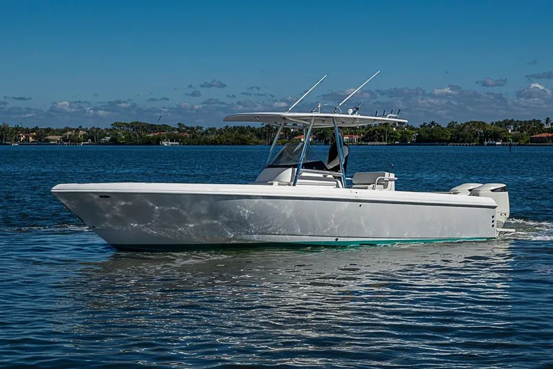  Yacht Photos Pics 2005 Intrepid 300 Center Console boat cruising on a sunny day.