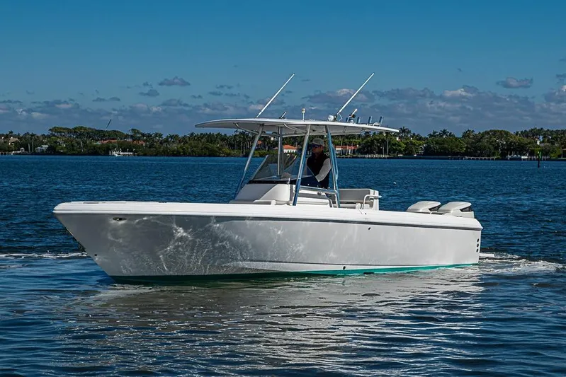 Yacht Photos Pics 2005 Intrepid 300 Center Console boat cruising on a sunny day.