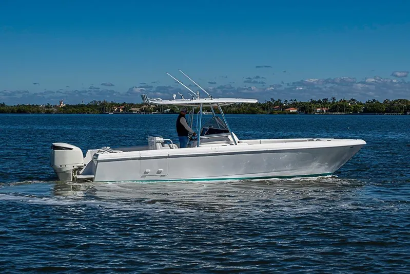  Yacht Photos Pics 2005 Intrepid 300 Center Console boat cruising on a sunny day.