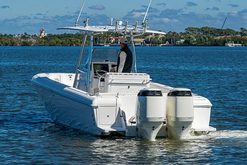  Yacht Photos Pics 2005 Intrepid 300 Center Console boat cruising on a sunny day.