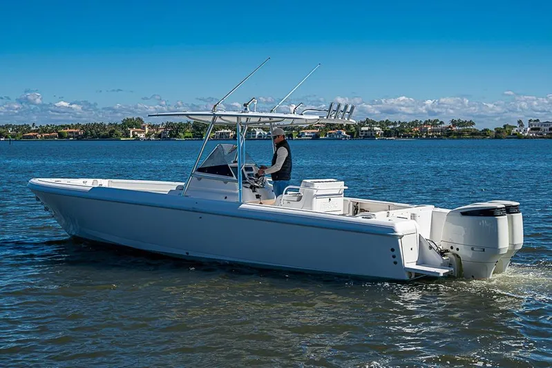  Yacht Photos Pics 2005 Intrepid 300 Center Console boat cruising on a sunny day.