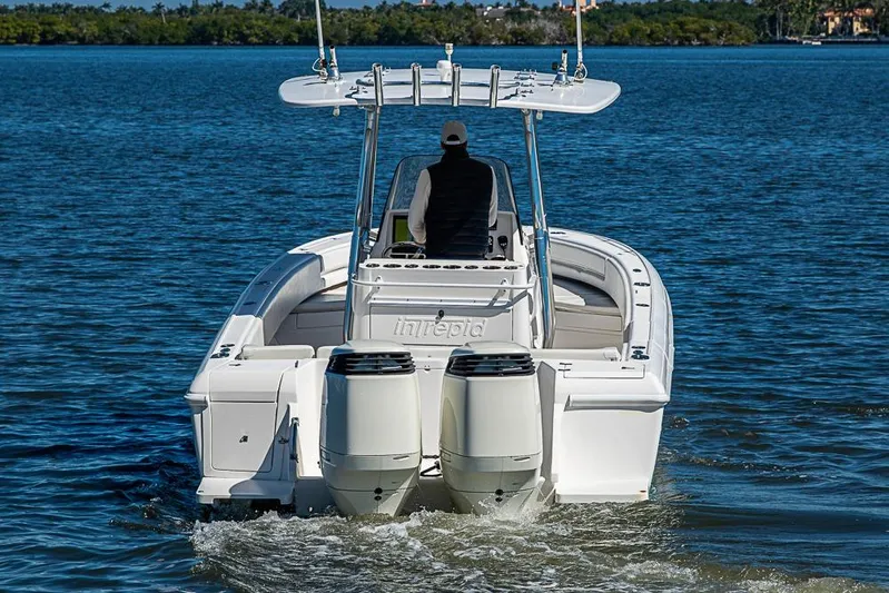  Yacht Photos Pics 2005 Intrepid 300 Center Console boat cruising on calm waters.