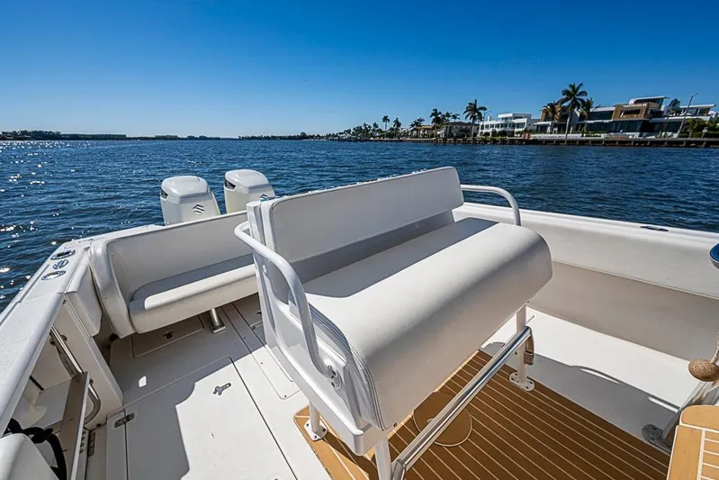  Yacht Photos Pics 2005 Intrepid 300 Center Console boat on sunny waterfront with modern seating.