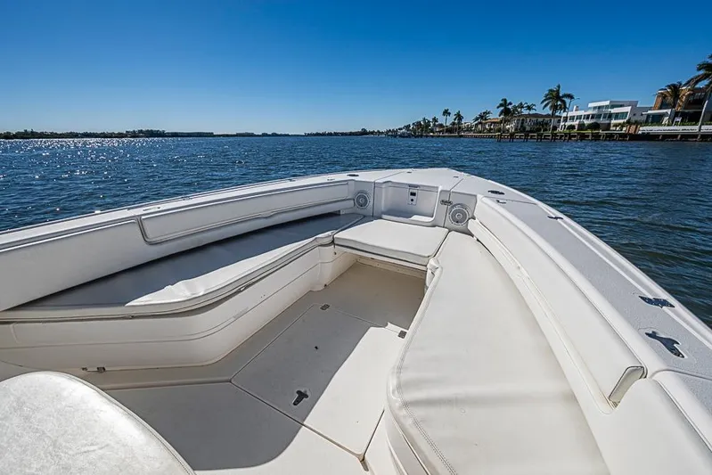  Yacht Photos Pics 2005 Intrepid 300 Center Console boat on calm water, clear sky, coastal view.