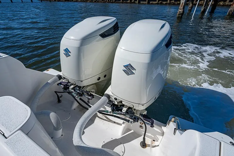  Yacht Photos Pics Twin Suzuki outboard engines on a 2005 Intrepid 300 Center Console boat in water.