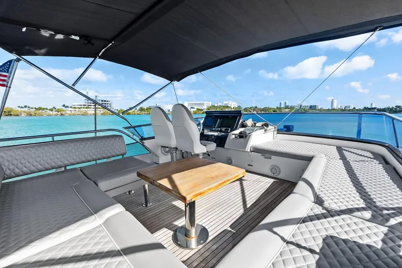 Panda Yacht Photos Pics Luxury Azimut 77S yacht deck with seating, table, and ocean view, 2017 model.