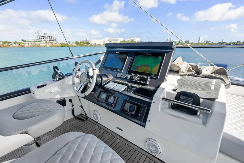 Panda Yacht Photos Pics 2017 Azimut 77S yacht helm with modern navigation equipment and luxurious seating.