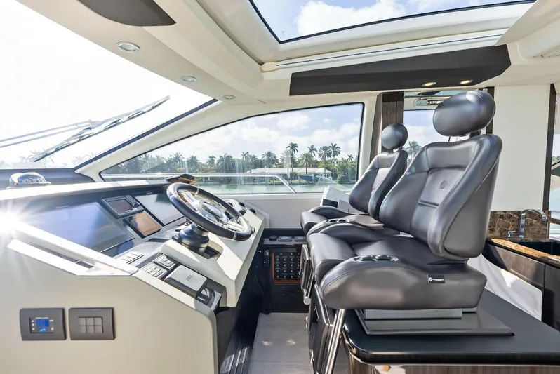 Panda Yacht Photos Pics Luxurious interior of 2017 Azimut 77S yacht with modern helm and leather seating.