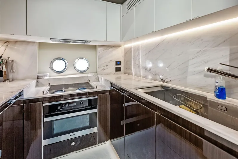 Panda Yacht Photos Pics Luxurious kitchen interior of 2017 Azimut 77S yacht with modern appliances and marble finishes.