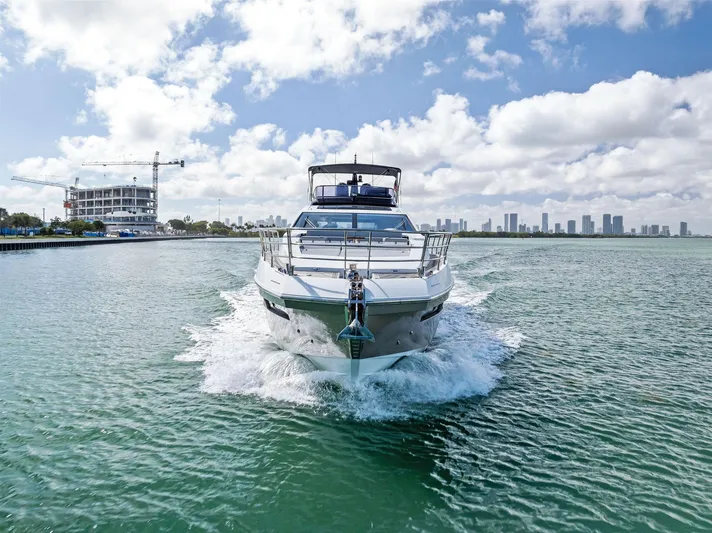 Panda Yacht Photos Pics Azimut 77S yacht cruising in open water, 2017 model, city skyline in background.