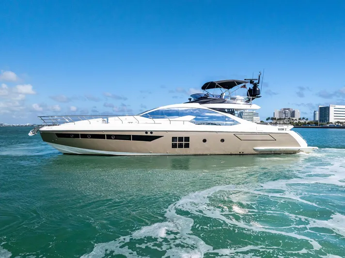 Panda Yacht Photos Pics Azimut 77S 2017 yacht cruising on clear blue waters near city skyline.