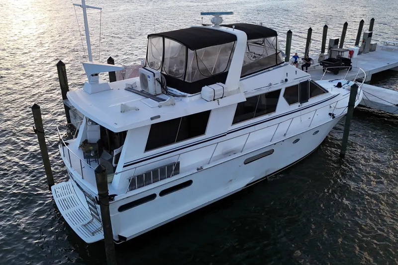  Yacht Photos Pics 1987 Viking Gulfstar yacht docked at marina, featuring sleek design and spacious upper deck.