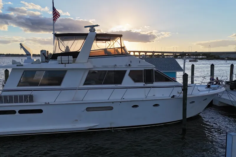  Yacht Photos Pics 1987 Viking Gulfstar yacht docked at sunset with American flag.