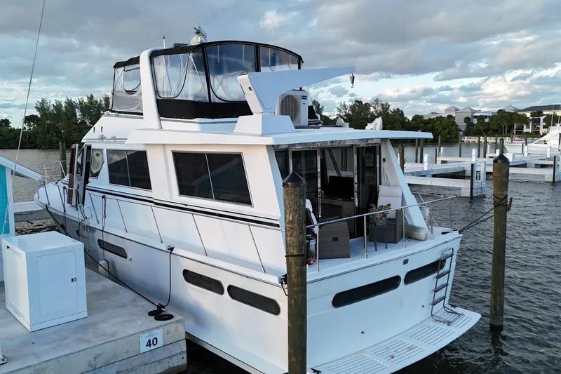  Yacht Photos Pics 1987 Viking Gulfstar yacht docked at marina, featuring spacious deck and modern design.