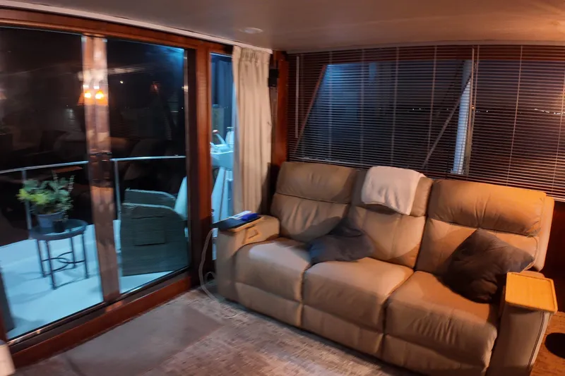  Yacht Photos Pics Cozy interior of 1987 Viking Gulfstar yacht with beige sofa and sliding glass doors.