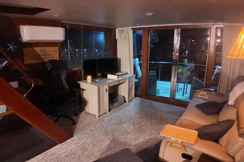  Yacht Photos Pics Cozy interior of 1987 Viking Gulfstar yacht with desk, chair, and sliding glass doors.