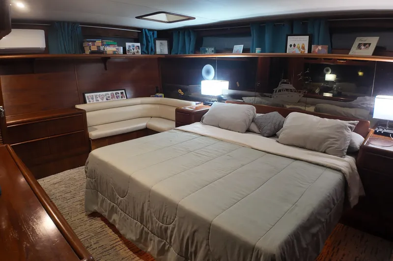  Yacht Photos Pics Luxurious bedroom interior of 1987 Viking Gulfstar yacht with elegant wood finishes and cozy bedding.