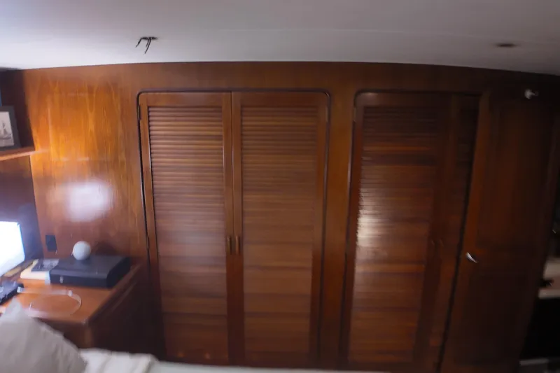  Yacht Photos Pics Wood-paneled interior of 1987 Viking Gulfstar yacht with louvered closet doors.