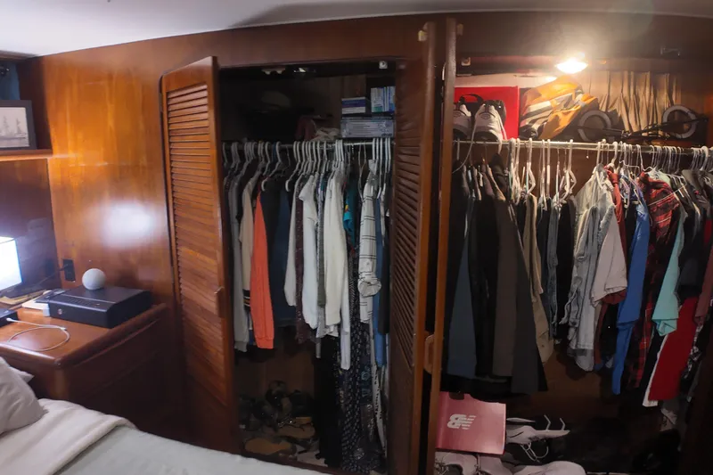  Yacht Photos Pics Closet interior on 1987 Viking Gulfstar yacht with clothes and shoes neatly organized.