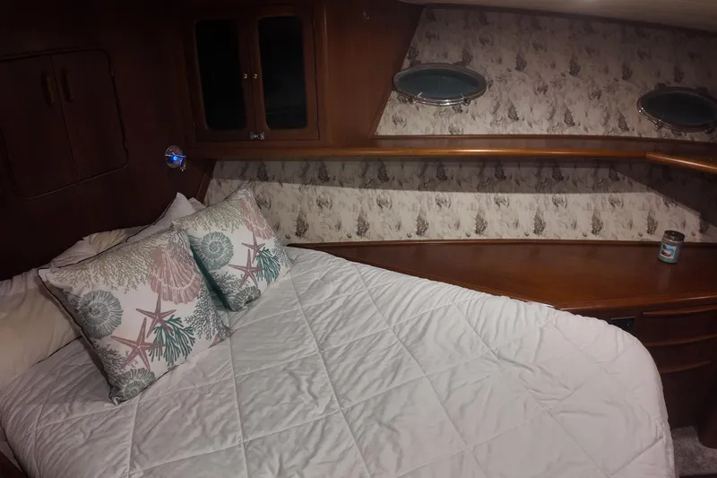  Yacht Photos Pics Cozy cabin interior of 1987 Viking Gulfstar with nautical-themed bedding and wooden accents.