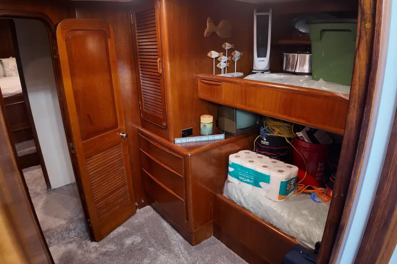  Yacht Photos Pics 1987 Viking Gulfstar interior with wooden cabinets, storage shelves, and various household items.